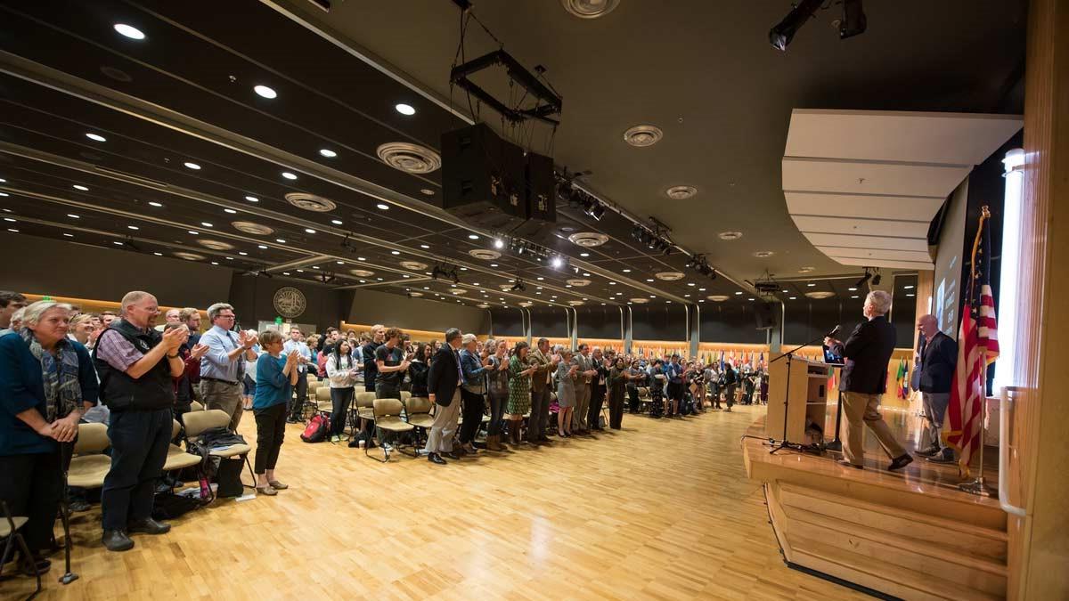 Audience applauds speaker in the International Ballroom