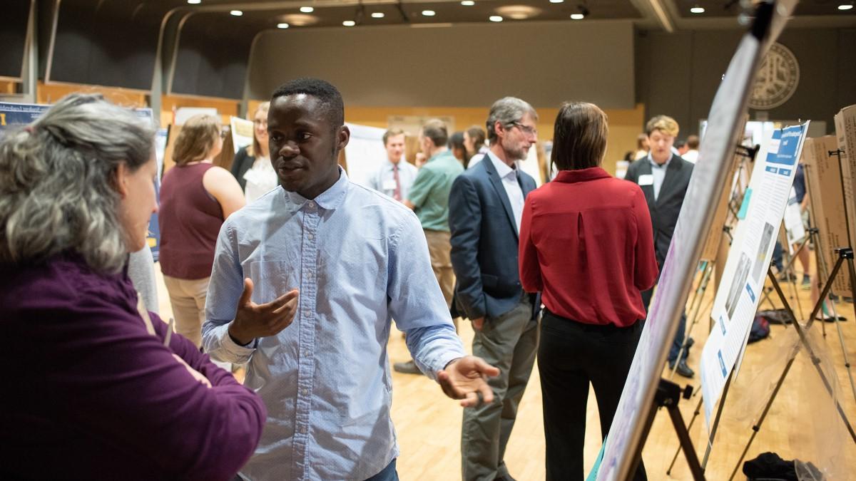 Visitors view exhibits during a symposium held in the International Ballroom